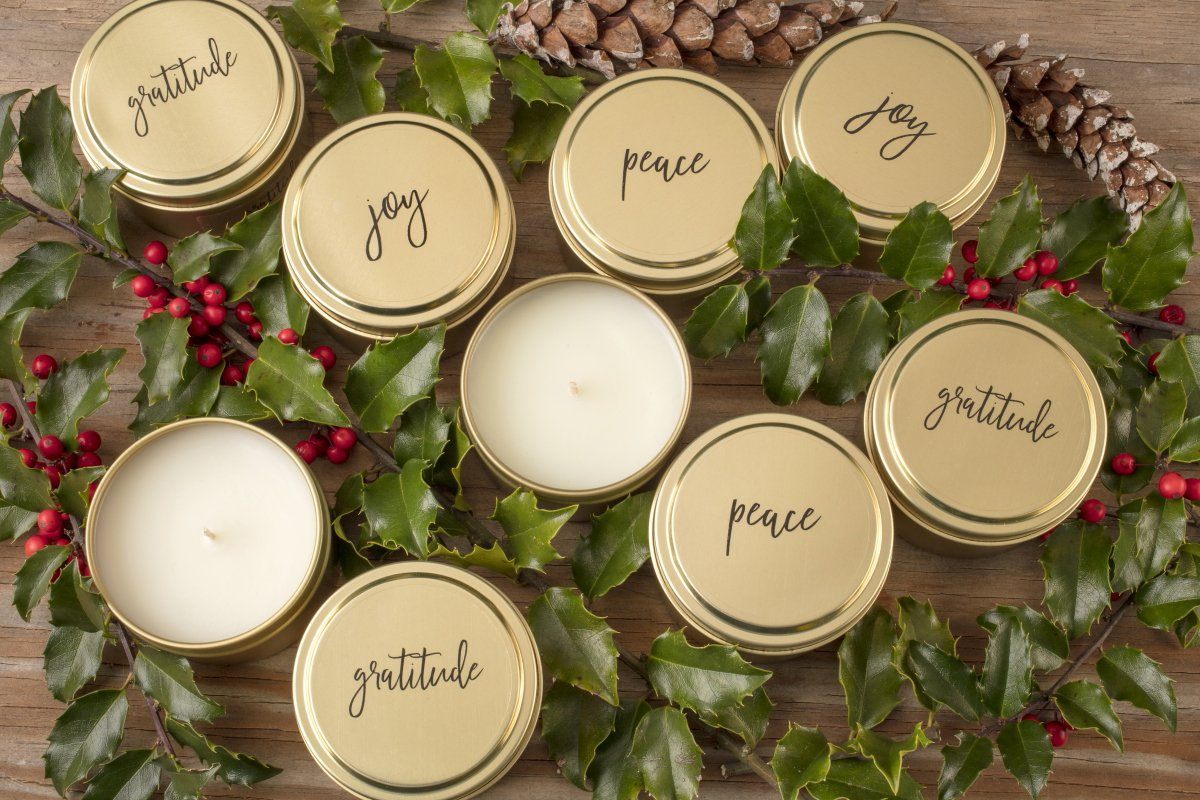 Peace, Joy and gratitude gold soy blend  wholesale candles handmade by women artisans in the United States. Best holiday gift that gives back. Gold travel tin candles add beauty to the home.